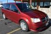 2014 Red /Black Dodge Grand Caravan SE (2C4RDGBGXER) with an 3.6L V6 VVT engine, 6-Speed Automatic transmission, located at 1600 E Hwy 44, Rapid City, SD, 57703, (605) 716-7878, 44.070232, -103.171410 - Photo#0